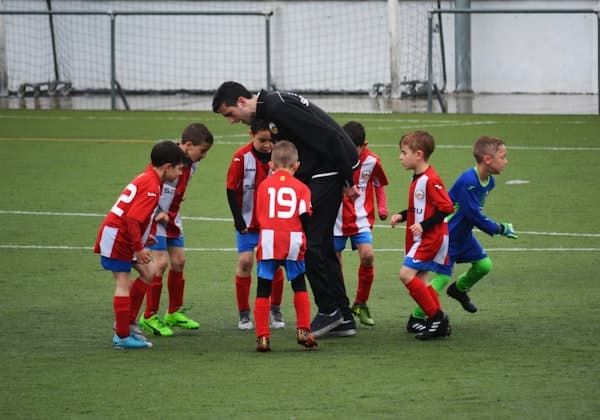Sports coach training a young athlete